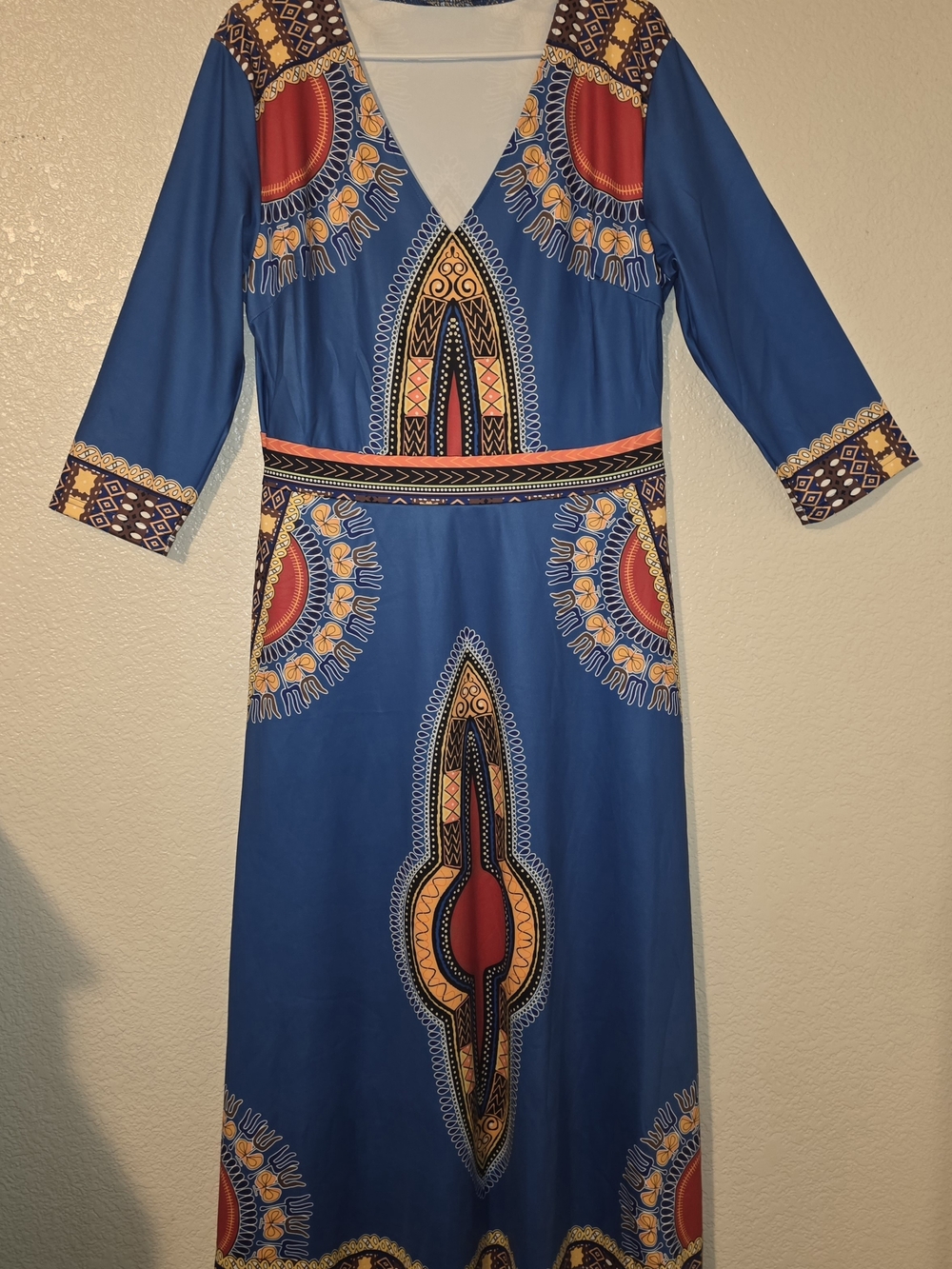 African-print maxi dress features a V-neckline and 3/4 sleeves with vibrant boho